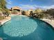 Relaxing community pool area showcasing refreshing, clear blue water with lush desert landscaping at 6631 E Rhodes St, Mesa, AZ 85215