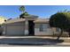 Charming single-story home with a well-maintained front yard and attached two-car garage at 6631 E Rhodes St, Mesa, AZ 85215