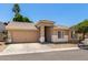 Inviting home with a well-manicured front yard, complemented by a tan exterior and a convenient two-car garage at 6631 E Rhodes St, Mesa, AZ 85215