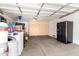 Spacious garage with storage cabinets and black refrigerator at 6631 E Rhodes St, Mesa, AZ 85215