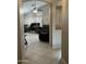 Hallway view into a dining and living area with tile flooring and neutral paint at 6631 E Rhodes St, Mesa, AZ 85215