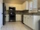 Modern kitchen with stainless steel appliances, white cabinets and granite countertops at 6631 E Rhodes St, Mesa, AZ 85215