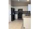 Modern kitchen with stainless steel appliances, white cabinets and granite countertops at 6631 E Rhodes St, Mesa, AZ 85215