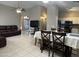 Open-concept living area with tile flooring, a vaulted ceiling and a comfortable leather sofa at 6631 E Rhodes St, Mesa, AZ 85215