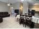 Open-concept living area with tile flooring, a vaulted ceiling and a comfortable leather sofa at 6631 E Rhodes St, Mesa, AZ 85215