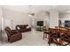 Open-concept living area featuring a leather sofa set, tile floors, and vaulted ceilings at 6631 E Rhodes St, Mesa, AZ 85215