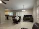 Bright living area featuring a dining table, workspace, and modern kitchen with neutral tones at 6631 E Rhodes St, Mesa, AZ 85215