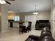 Spacious living area with kitchen, dining table, and a comfortable workspace at 6631 E Rhodes St, Mesa, AZ 85215