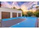 Private outdoor basketball court with a three-car garage and desert landscaping at 6831 E Presidio Rd, Scottsdale, AZ 85254
