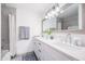 Bright bathroom featuring dual sinks, ample counter space, modern lighting, and a tub/shower combo at 6831 E Presidio Rd, Scottsdale, AZ 85254