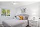 Airy bedroom featuring a plush bed, neutral tones, and a view of the outdoors through the window at 6831 E Presidio Rd, Scottsdale, AZ 85254