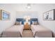 Bright bedroom with two twin beds, complemented by tasteful decor and natural light at 6831 E Presidio Rd, Scottsdale, AZ 85254