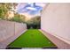 Well-maintained bocce ball court with artificial turf and decorative landscape border at 6831 E Presidio Rd, Scottsdale, AZ 85254