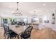Open concept dining area with modern chandelier, wood table and view of living room and kitchen at 6831 E Presidio Rd, Scottsdale, AZ 85254