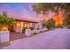 Charming home exterior showcasing a covered entryway, brick walkway and beautiful landscaping at sunset at 6831 E Presidio Rd, Scottsdale, AZ 85254