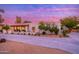 Charming single-story home exterior with desert landscaping, and a circular driveway at 6831 E Presidio Rd, Scottsdale, AZ 85254