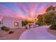 Exterior view of a charming single story home with a circular driveway and desert landscaping at 6831 E Presidio Rd, Scottsdale, AZ 85254