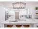 Bright kitchen with white cabinets, quartz countertops, stainless steel appliances, and wood accents at 6831 E Presidio Rd, Scottsdale, AZ 85254