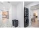 Modern laundry area with stacked washer/dryer, decorative flooring, and easy access to other rooms at 6831 E Presidio Rd, Scottsdale, AZ 85254