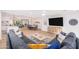 Bright living room with a gray sectional sofa open to the dining area and kitchen at 6831 E Presidio Rd, Scottsdale, AZ 85254