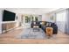 Bright living room with a gray sectional sofa, wood accents, and sliding glass doors at 6831 E Presidio Rd, Scottsdale, AZ 85254