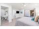 Serene primary bedroom with a slider to the backyard, TV, and ensuite bathroom at 6831 E Presidio Rd, Scottsdale, AZ 85254