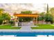 Outdoor kitchen with grill, bar seating, and shade from the bright sun at 6831 E Presidio Rd, Scottsdale, AZ 85254