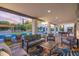 Stylish covered patio with comfortable seating, lounge area, and pool access at 6831 E Presidio Rd, Scottsdale, AZ 85254
