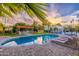 Beautiful backyard pool area featuring lounge chairs, grilling area, and lush landscaping at 6831 E Presidio Rd, Scottsdale, AZ 85254