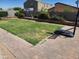 The backyard features a grassy lawn, brick patio, block fence, and mature landscaping at 7251 E Grouse Ct, San Tan Valley, AZ 85143