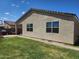 Backyard features a manicured lawn, stucco home exterior, and shaded patio area at 7251 E Grouse Ct, San Tan Valley, AZ 85143