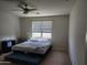 Bright bedroom with neutral walls, a window with natural light, and a comfortable bed at 7251 E Grouse Ct, San Tan Valley, AZ 85143