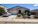 Charming single-story home with a two-car garage, low maintenance landscaping, and mature plants in the front yard at 7251 E Grouse Ct, San Tan Valley, AZ 85143