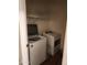 Functional laundry room with a washer and dryer set and storage shelves above at 7251 E Grouse Ct, San Tan Valley, AZ 85143