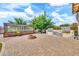 Backyard featuring an outdoor kitchen, fire pit, brick patio, a gardening enclosure and a green lawn at 747 E Meadow Ln, Phoenix, AZ 85022