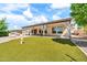 Home's backyard includes a patio, artificial grass, a fire hydrant, and a full outdoor kitchen at 747 E Meadow Ln, Phoenix, AZ 85022