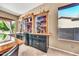 Bar area with custom cabinets and views to the outdoor at 747 E Meadow Ln, Phoenix, AZ 85022