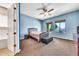 A spacious bedroom featuring carpet, a ceiling fan, and a bench at 747 E Meadow Ln, Phoenix, AZ 85022