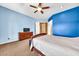 This spacious bedroom includes a dark wood dresser and a TV at 747 E Meadow Ln, Phoenix, AZ 85022