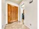 Entryway with tiled floors leading past a light-wood door to a room with a washer and dryer at 747 E Meadow Ln, Phoenix, AZ 85022