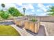 Raised garden beds with rustic wood paneling and wire enclosures sit on a paved patio, ready for planting at 747 E Meadow Ln, Phoenix, AZ 85022