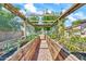 A lush, plant-filled greenhouse with gravel floor and wooden frame, creating an organized gardening space at 747 E Meadow Ln, Phoenix, AZ 85022