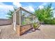 Backyard greenhouse featuring wood framing and mesh walls, creating an ideal space for cultivating plants at 747 E Meadow Ln, Phoenix, AZ 85022