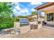 Outdoor grill area equipped with a stainless steel grill, sink, storage and a brick-paved patio at 747 E Meadow Ln, Phoenix, AZ 85022