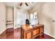 Office with a large wooden desk and custom shelving, and a window for natural light at 747 E Meadow Ln, Phoenix, AZ 85022