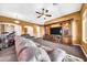 Expansive living room featuring brown carpeting, a large media center, a gray sofa, an archway and a drum set at 747 E Meadow Ln, Phoenix, AZ 85022