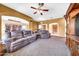 Comfortable living room with brown carpeting, two sofas, a music set, a wooden cabinet, and an archway to another room at 747 E Meadow Ln, Phoenix, AZ 85022