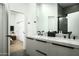 Modern bathroom with double sinks, white marble countertops, matte black fixtures, and a door to the bedroom at 7614 E Cactus Wren Rd, Scottsdale, AZ 85250