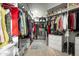 Spacious walk-in closet with built-in shelving, clothes racks, drawers, and a decorative rug at 7614 E Cactus Wren Rd, Scottsdale, AZ 85250
