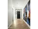 Bright entryway featuring hardwood floors, modern art, and a stylish black front door with sidelights at 7614 E Cactus Wren Rd, Scottsdale, AZ 85250